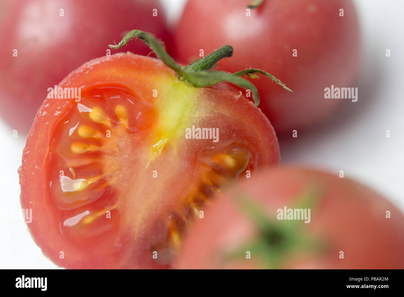 Fresh tomatoes on white background. Top view. With splashes of water ...