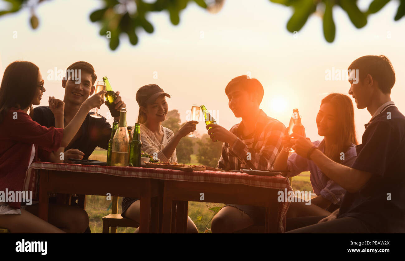 Group of 6 teenager have dinner party celebrating at sunset with