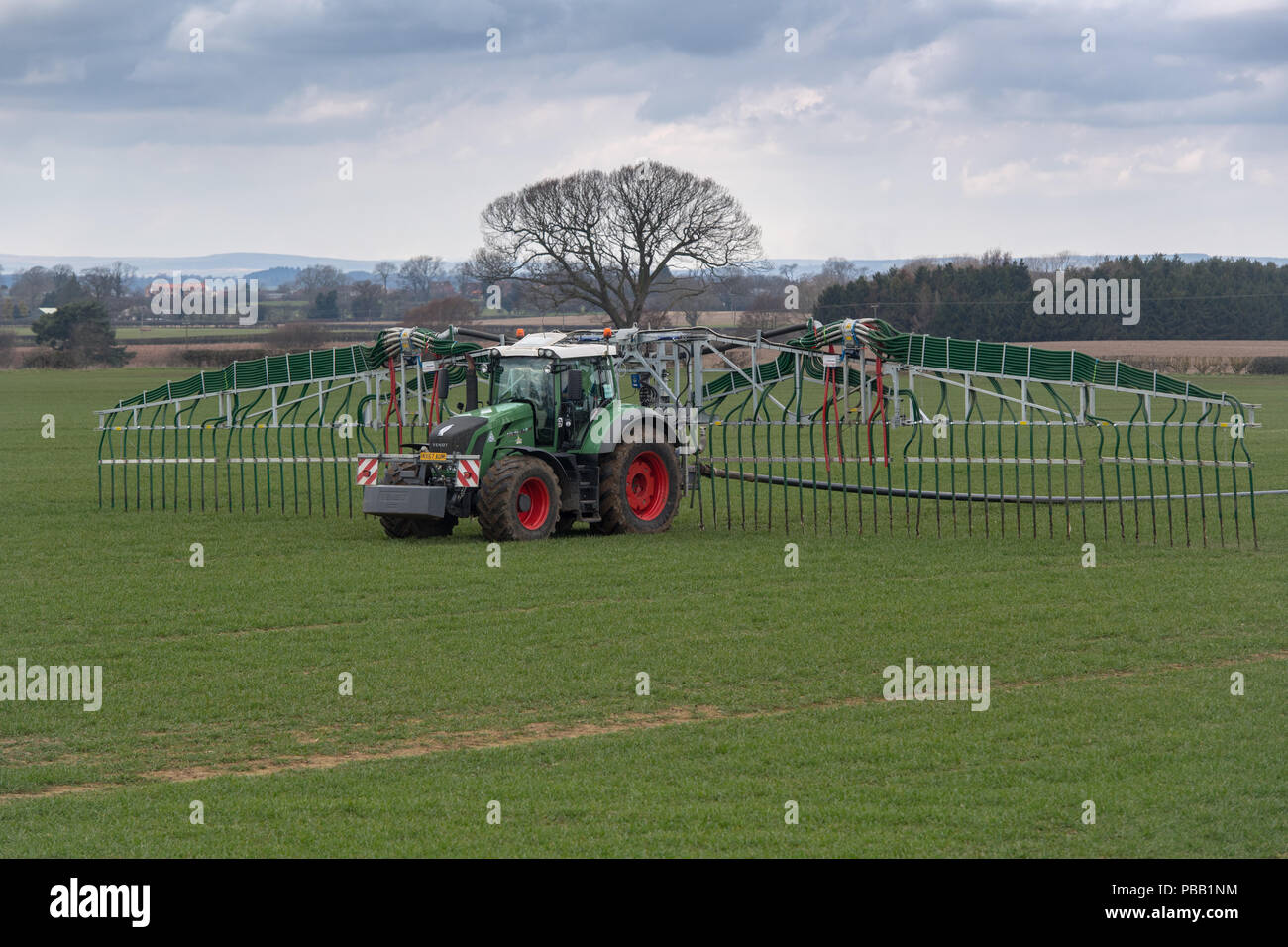 Spreading slurry with an umbilical system on a Fendt 828 tractor, to minimise soil compaction. North Yorkshire, UK. Stock Photo