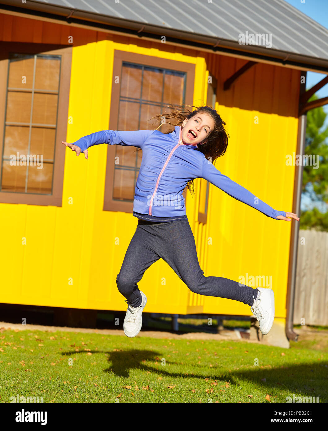 Teen girls in the park junping and having fun outdoors in sunny day Stock Photo