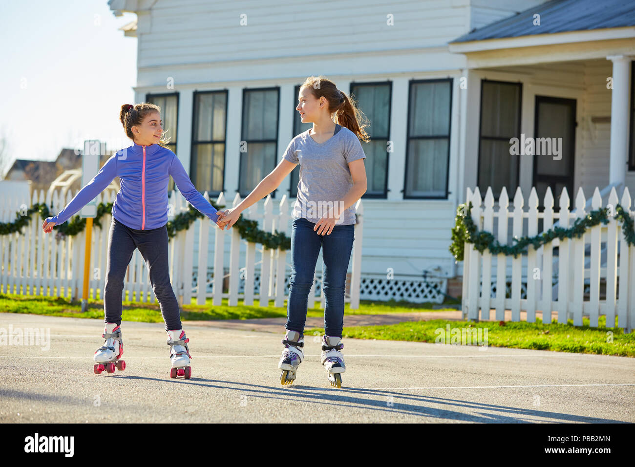 Teen girls group rolling skate in the street outdoor Stock Photo