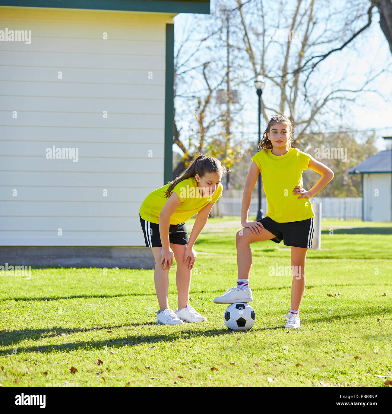 Teen girls group exercise soccer workout at park Stock Photo