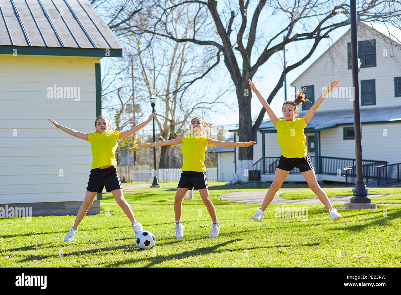 Teen girls group exercise workout jumnping at park Stock Photo