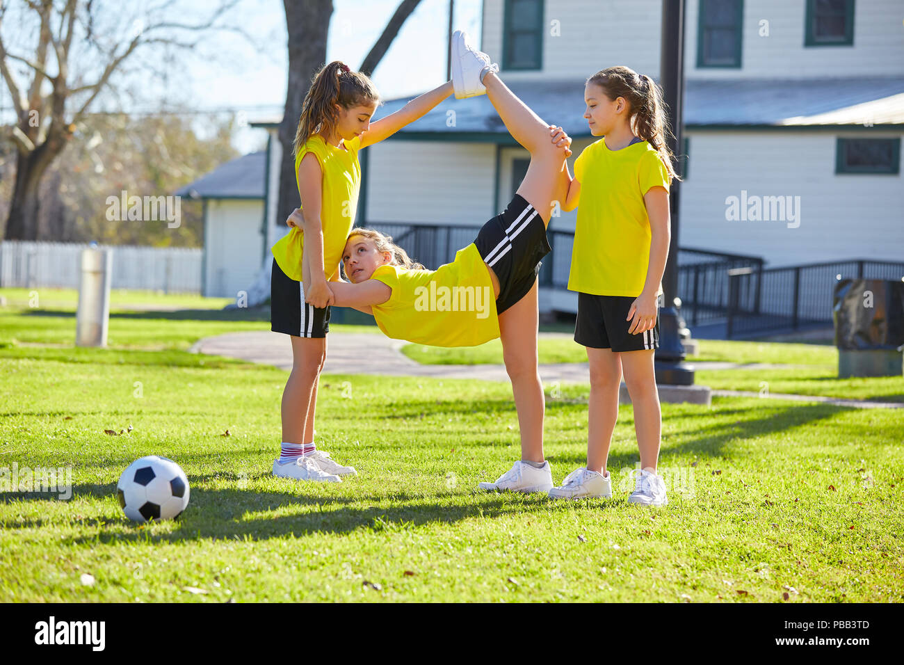 Teen girls group exercise workout stretching at park Stock Photo