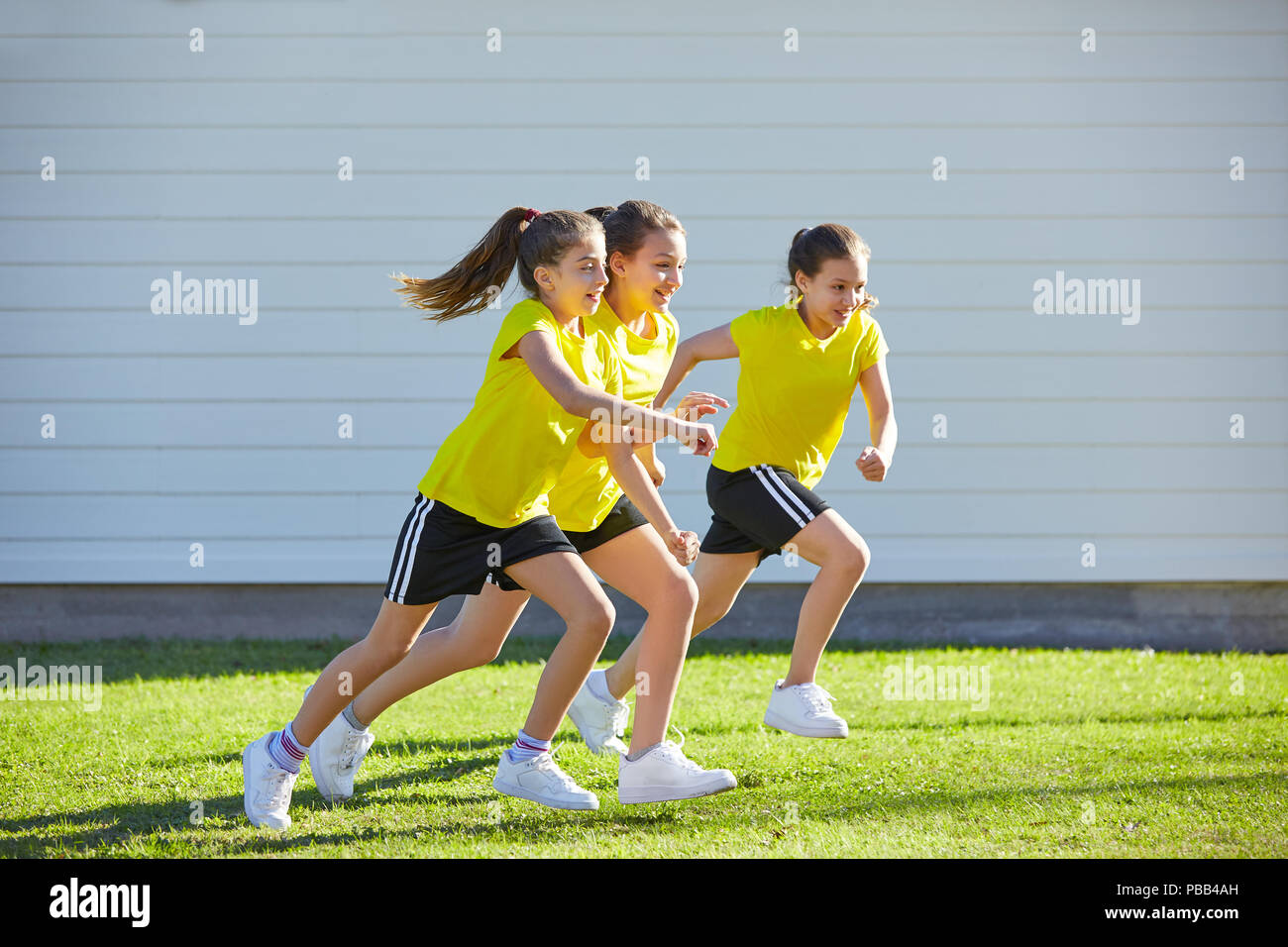 Teen girls group running workout at park outdoor Stock Photo
