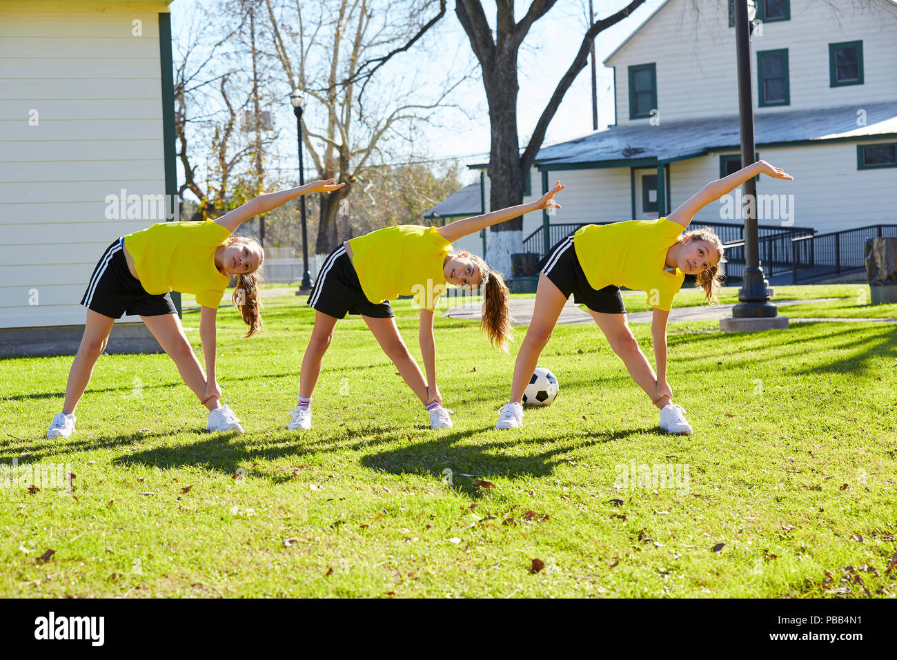 Teen girls group exercise workout at park Stock Photo