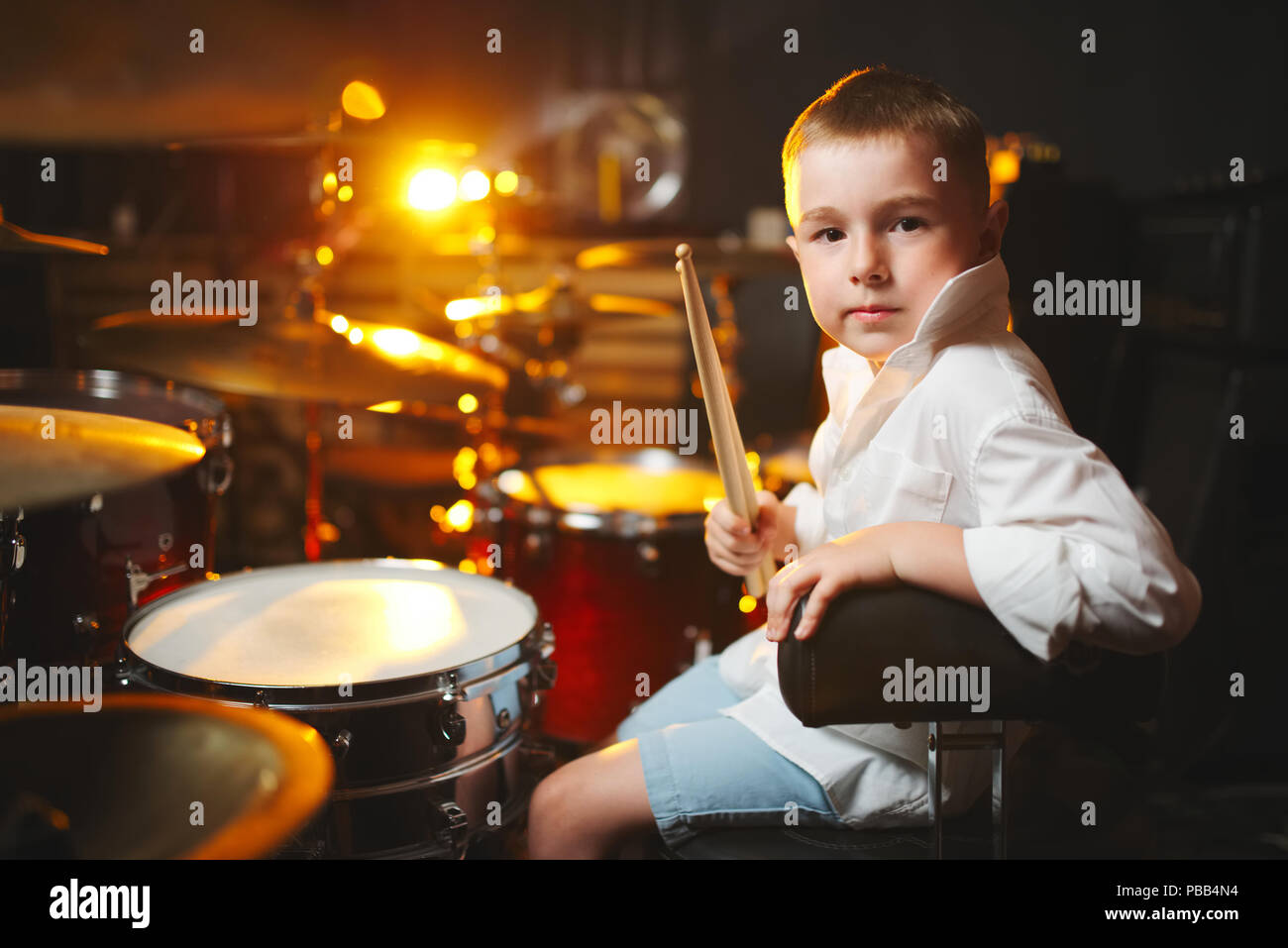 little boy plays drums in recording studio Stock Photo Alamy