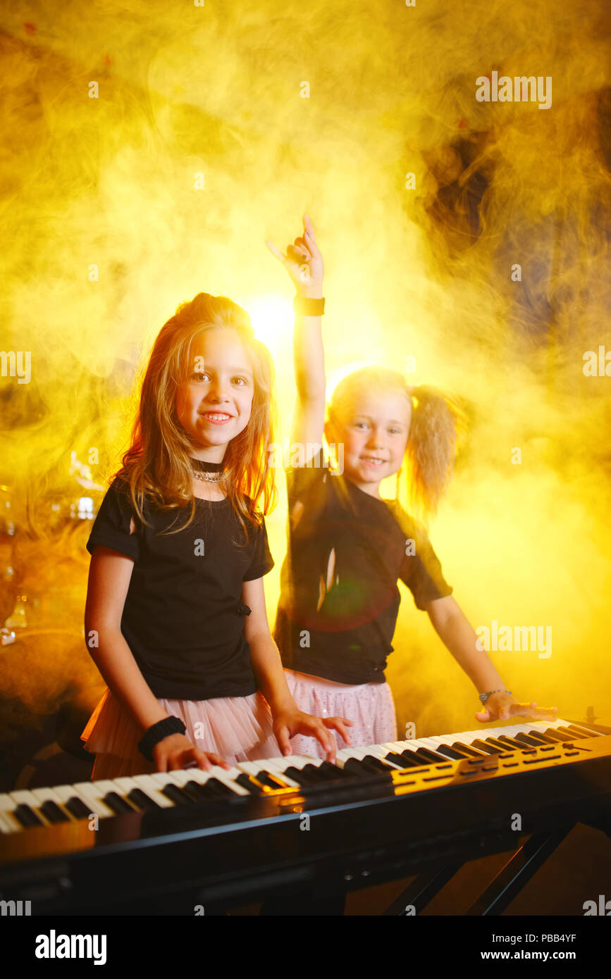little funny girl play on synthesizer in music studio Stock Photo Alamy
