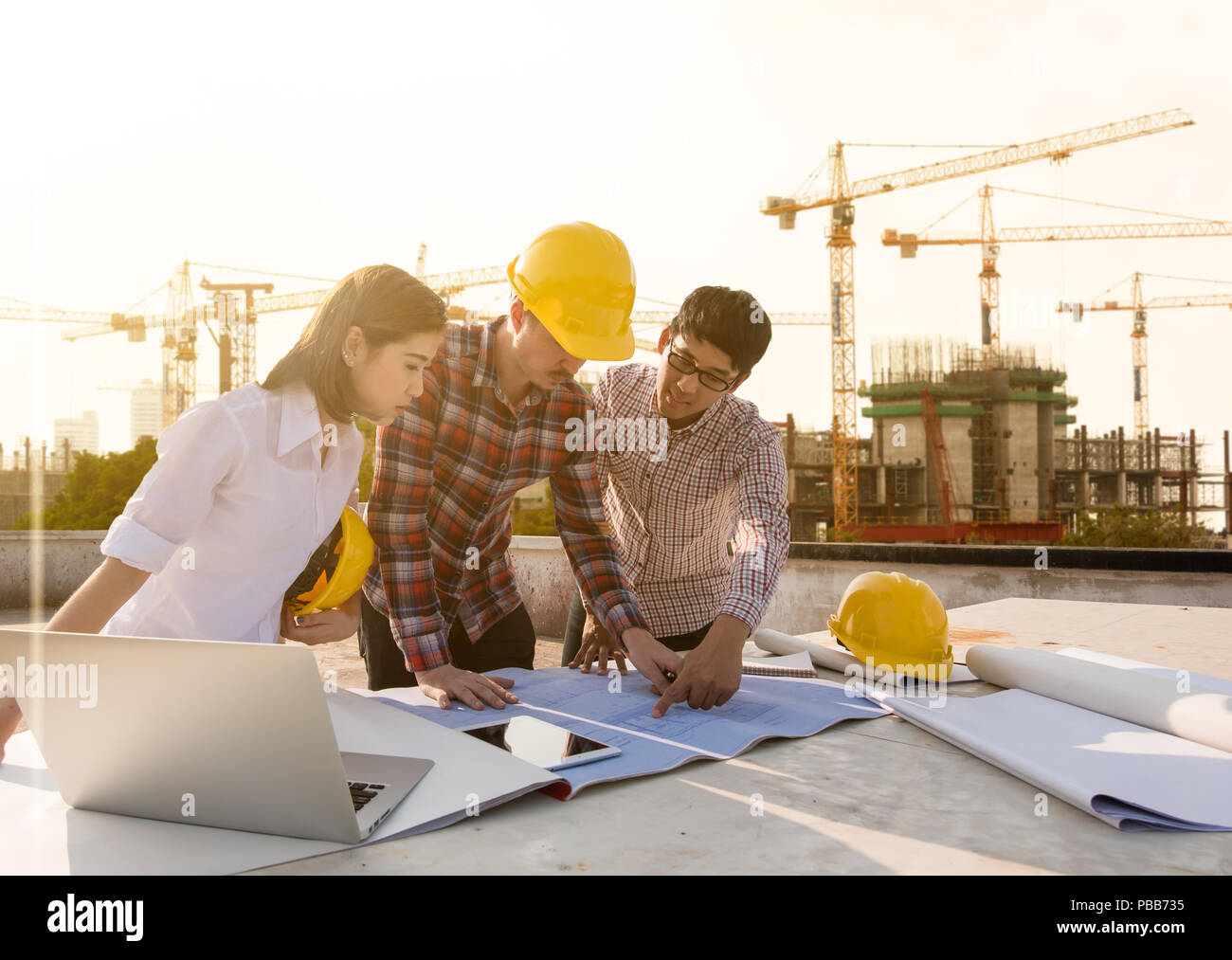 three construction engineers working together in construction site planning for the renovation Stock Photo