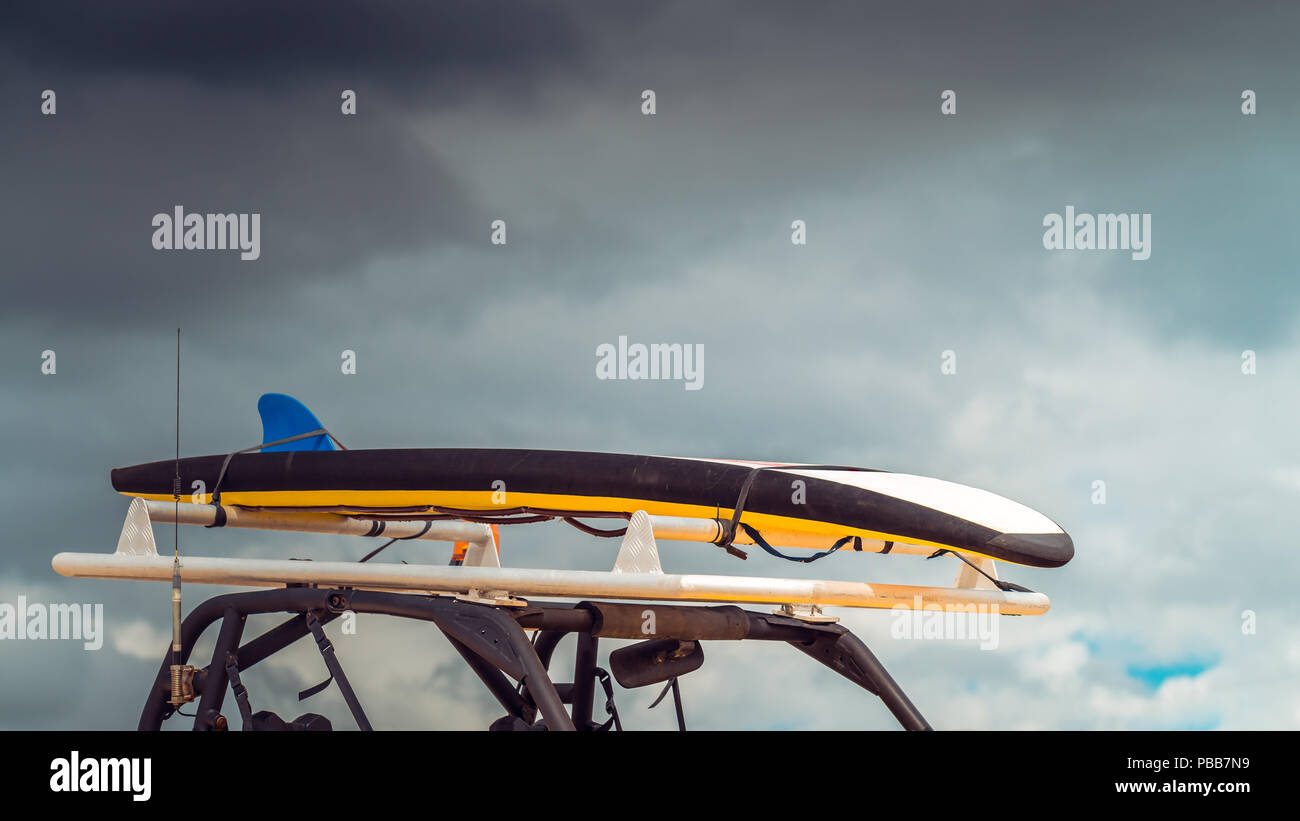 Surf life saving special vehicle with surfing board on top Stock Photo