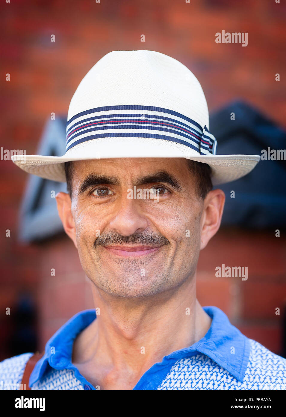 Close-up, front view portrait of smiling caucasian gentleman in straw panama hat outdoors at the Black Country Living Museum 1940's event, July 2018. Stock Photo