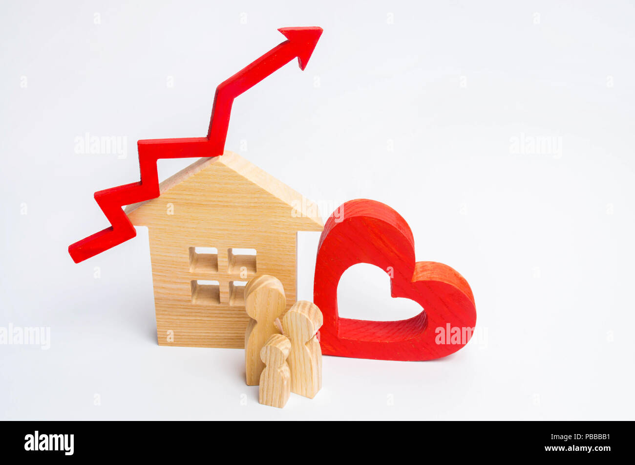 wooden house and family with a red arrow up. concept of high demand for real estate. increase energy efficiency of housing. rise in house prices. prop Stock Photo