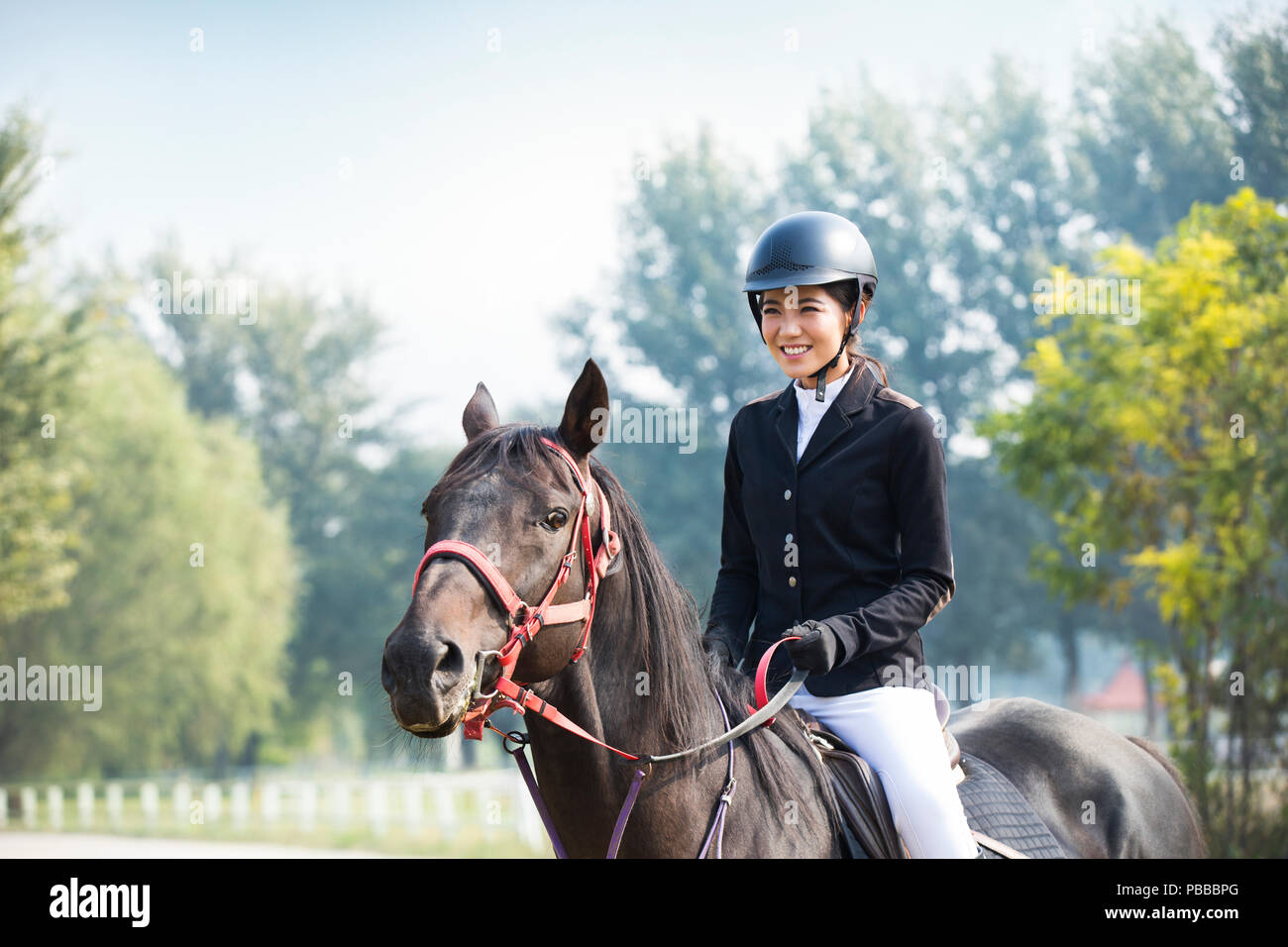 Chinese young woman riding horse hires stock photography and images