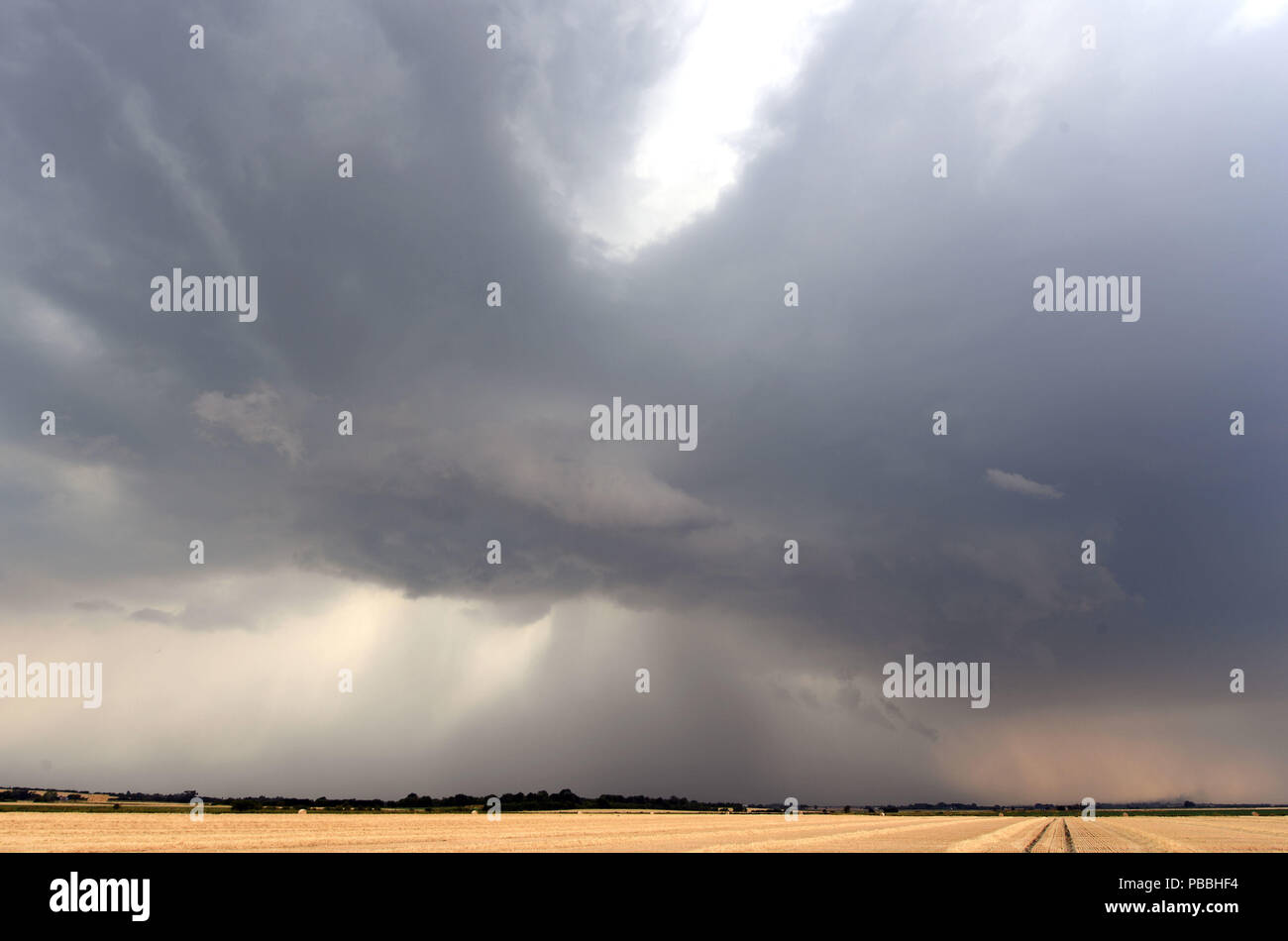Dark storm clouds over fields in Ely, Cambridgeshire Stock Photo - Alamy