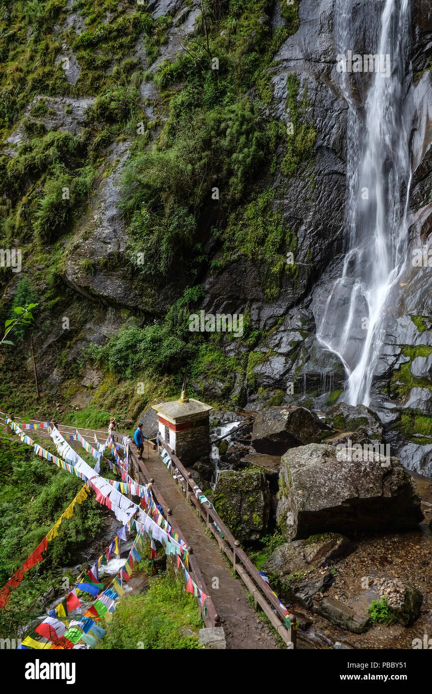 Waterfall with forest trail to Taktshang Goemba (or Tiger Nest) Monastery in Paro, Bhutan. Stock Photo