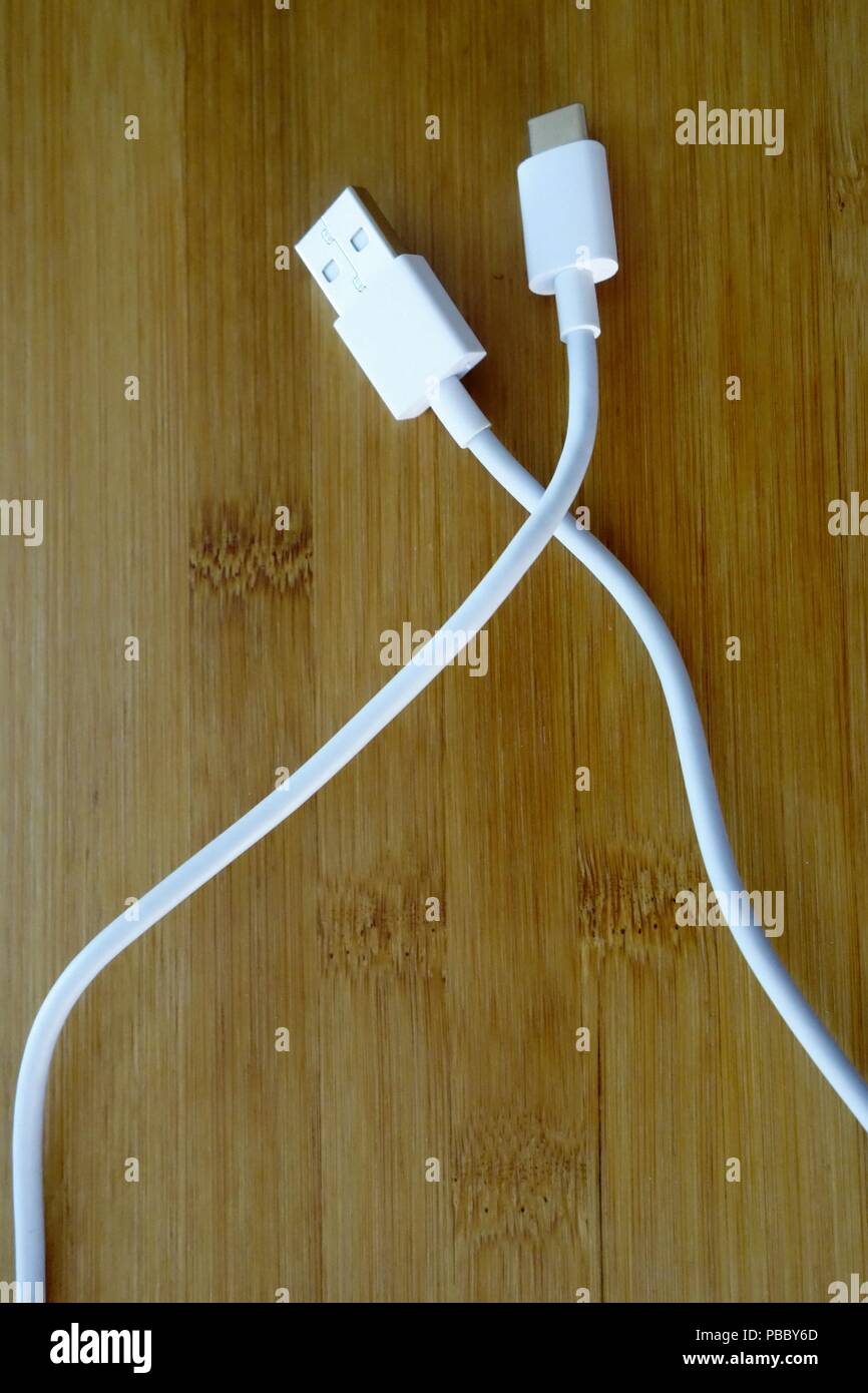 USB type C and USB 3.0 cables on wooden background Stock Photo