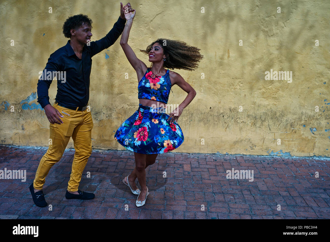 Two Colombian salsa dance instructors improvise a fun salsa dance at the Plaza del Reloj Stock Photo