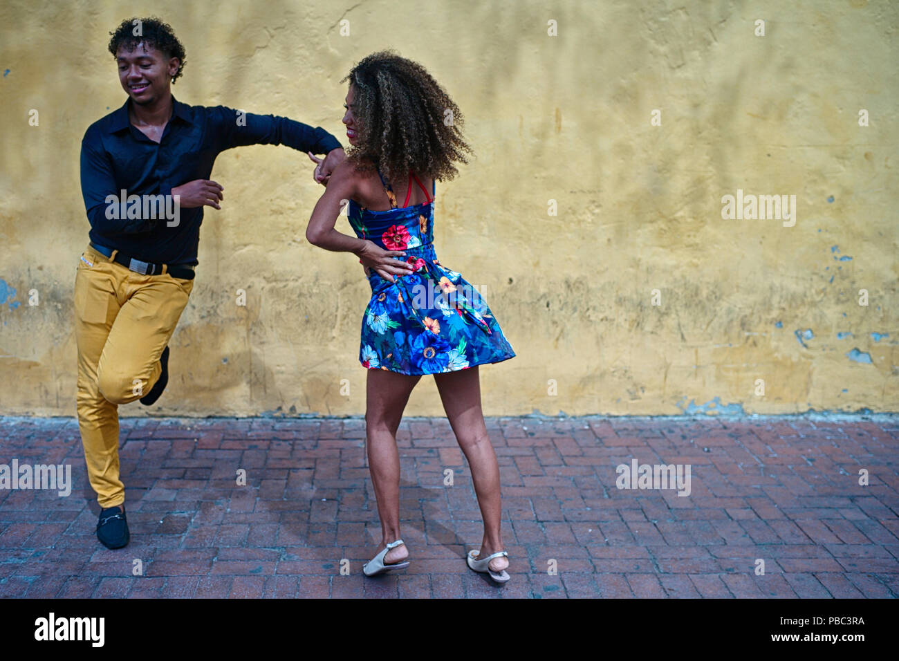 Two Colombian salsa dance instructors improvise a fun salsa dance at the Plaza del Reloj Stock Photo