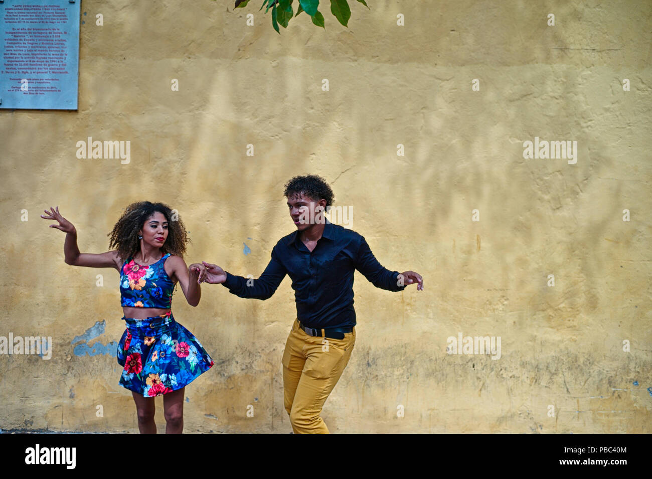 Two Colombian salsa dance instructors improvise a fun salsa dance at the Plaza del Reloj Stock Photo