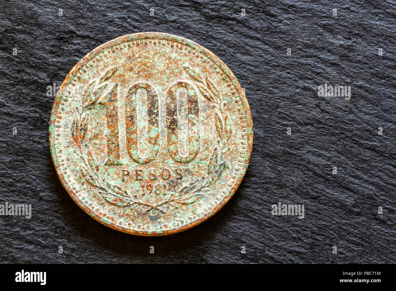 Corroded coin of 100 Chilean pesos from 1981. Stock Photo