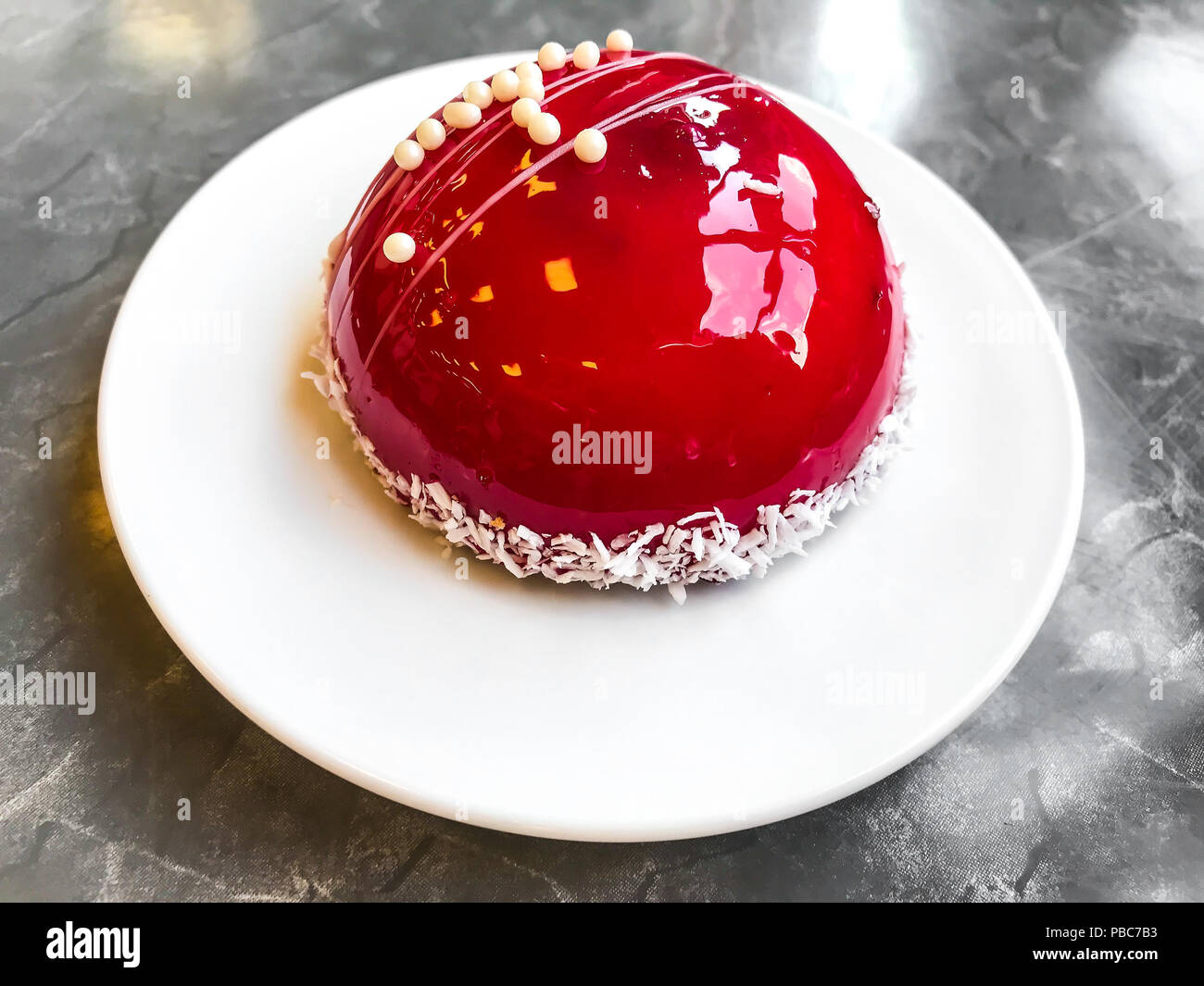 Mousse cake with red mirror glaze. Studio Photo Stock Photo
