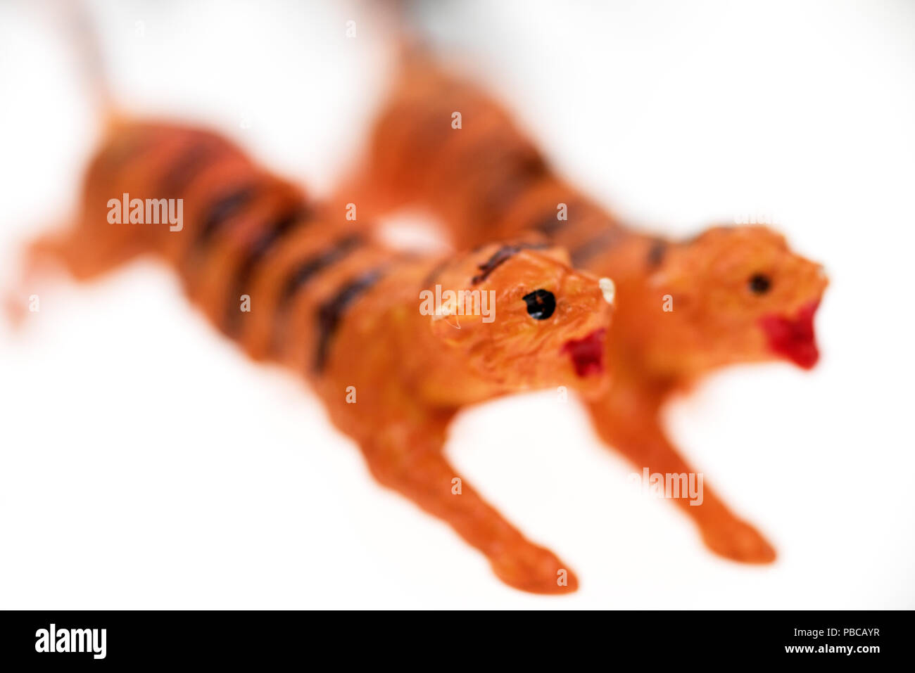 Toy tigers from a vintage Noah's Ark play set, photographed on a white