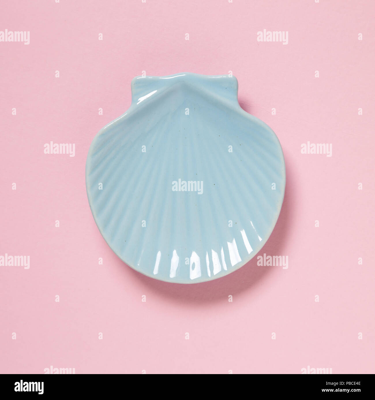 Sea shell shaped dish isolated on pink background Stock Photo
