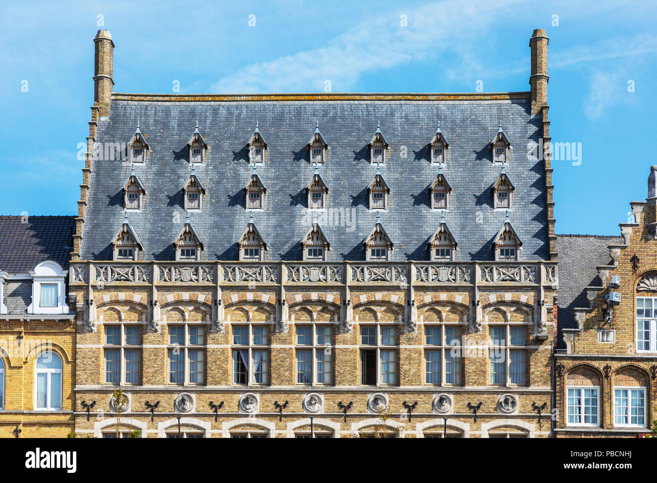 Flemish architecture with attic windows and ornate arches in the Old Seignory building, Grote Markt, Ypres, Belgium Stock Photo