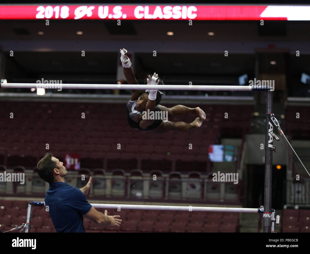 Ohio, USA. 27th July 2018.  SIMONE BILES receives a spot on the uneven bars from coach Laurent Landi during podium training at the G.K. U.S. Classic. This is Biles' first competition since winning the gymnastics all-around gold at the 2016 Rio Olympic Games. Melissa J. Perenson/CSM Credit: Cal Sport Media/Alamy Live News Stock Photo