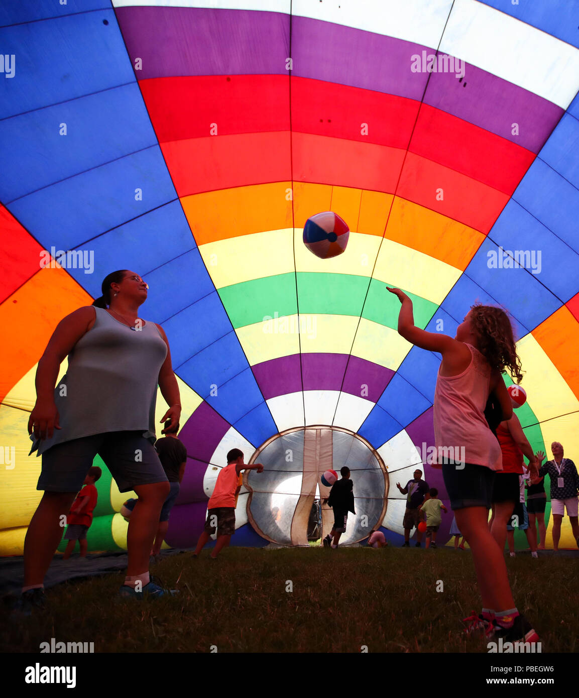 New Jersey, USA. 27th July, 2018. People take a tour inside an inflated balloon during the 36th Quickcheck New Jersey Festival of Ballooning in Readington of New Jersey, the United States, July 27, 2018. The three-day festival which kicked off on Friday, features mass inflation and ascension of up to 100 hot air balloons during the weekend, expected to attract 165,000 people. Credit: Wang Ying/Xinhua/Alamy Live News Stock Photo