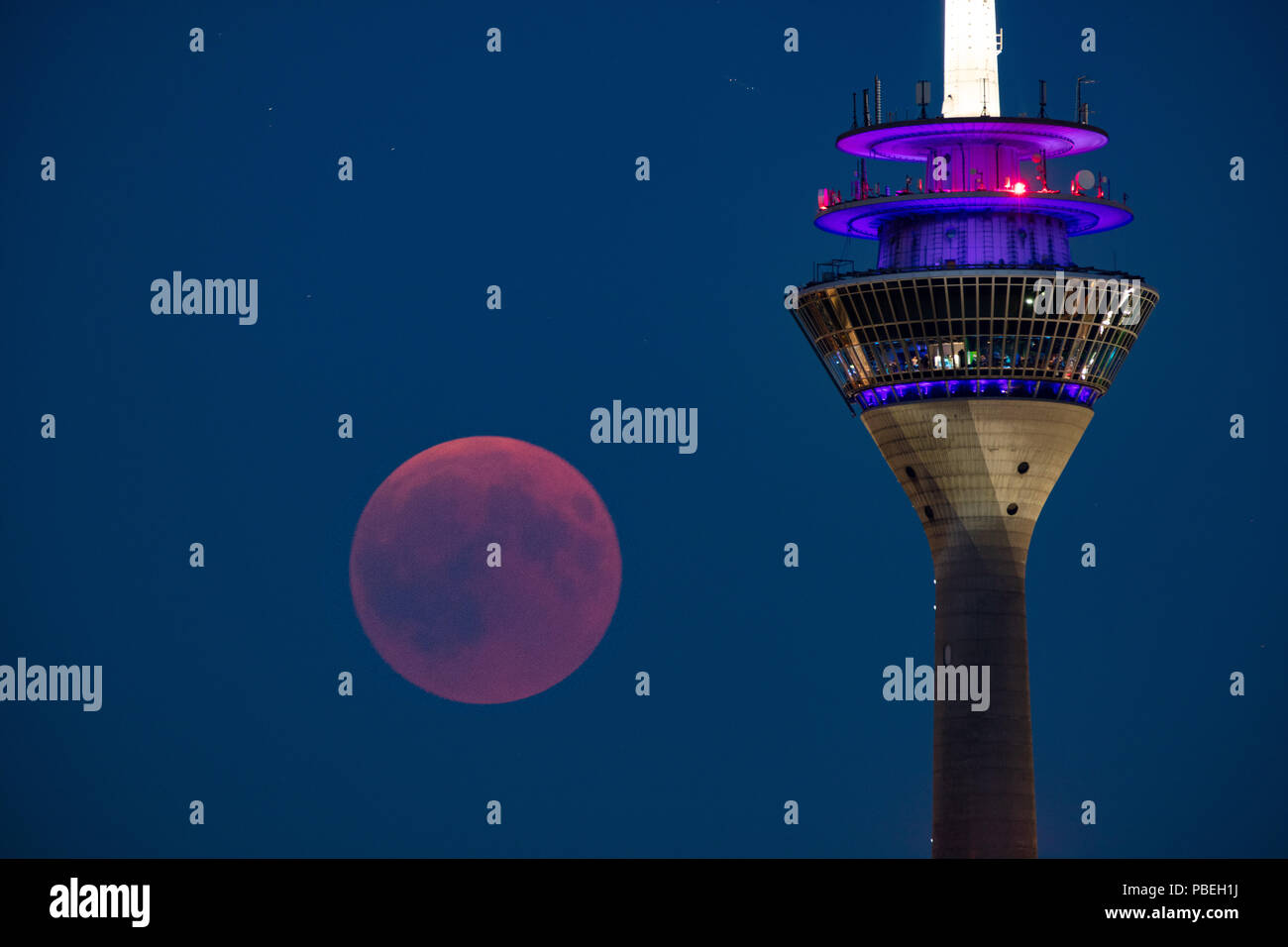 Düsseldorf, Germany. 27th July 2018. Moon Eclipse over Düsseldorf Credit: Jochen Brood/Alamy Live News Stock Photo