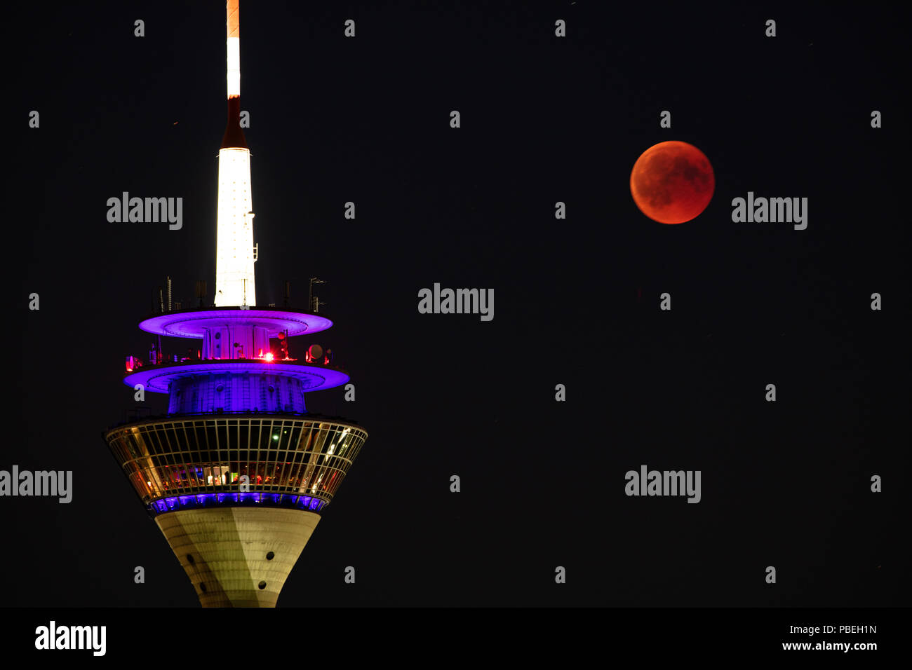 Düsseldorf, Germany. 27th July 2018. Moon Eclipse over Düsseldorf Credit: Jochen Brood/Alamy Live News Stock Photo