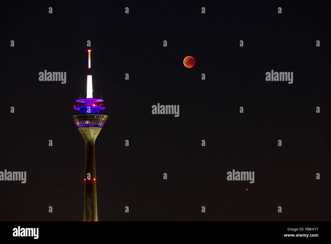 Düsseldorf, Germany. 27th July 2018. Moon Eclipse over Düsseldorf Credit: Jochen Brood/Alamy Live News Stock Photo