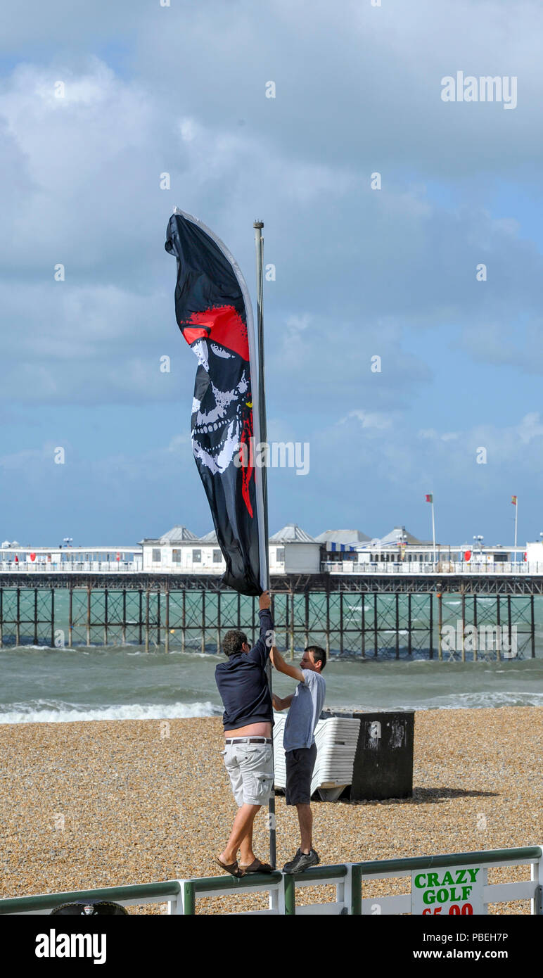 Brighton UK 28th July 2018 - Brighton seafront traders prepare for the day despite the high winds after weeks of hot weather . Thunderstorms and wind have swept across Britain overnight after the recent heatwave conditions Credit: Simon Dack/Alamy Live News Stock Photo