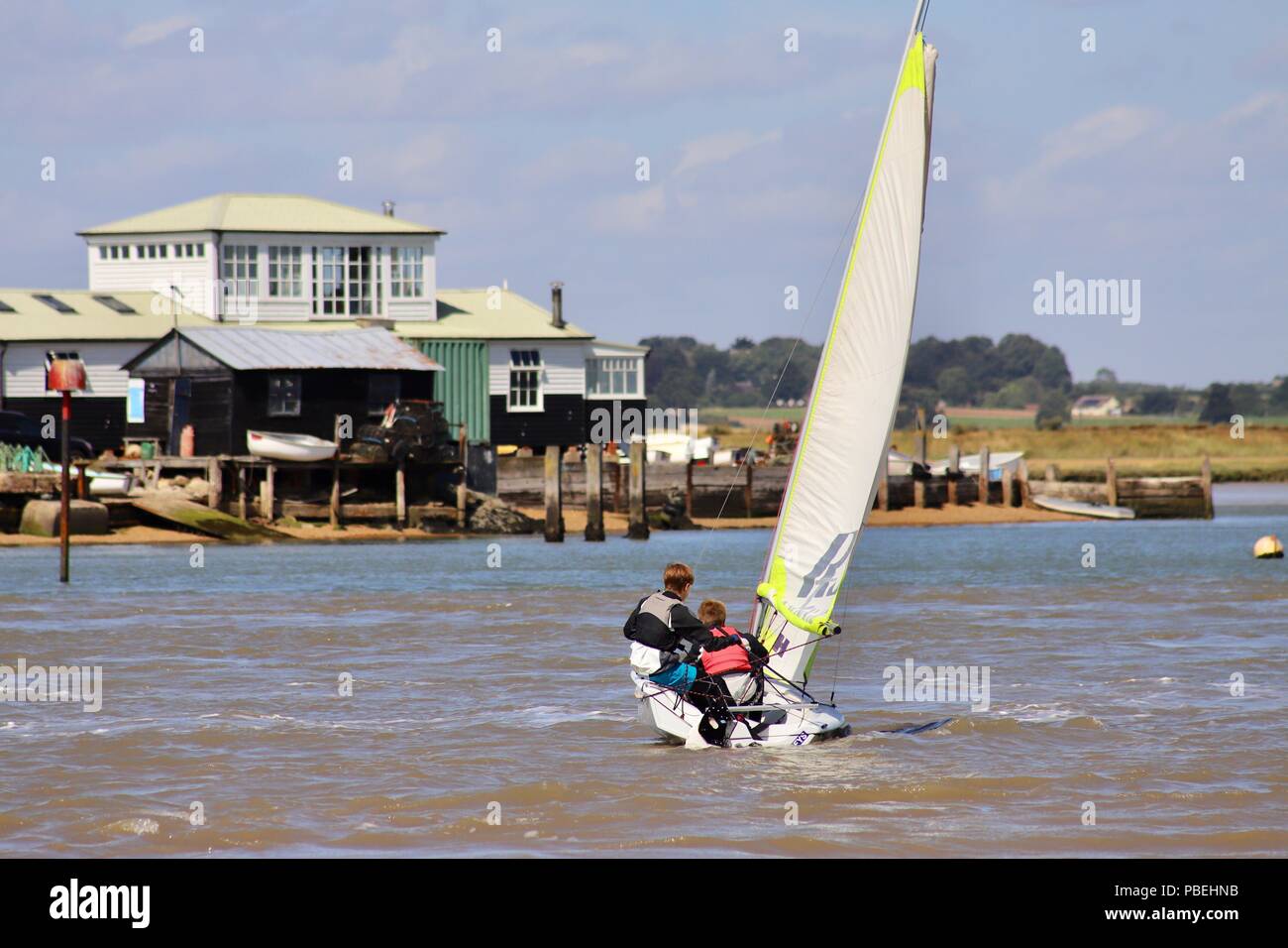 Suffolk, UK. 28th July 2018. UK Weather: Dinghy sailors contending with strong gusty winds this morning on the River Deben at Felixstowe Ferry, Suffolk. Credit: Angela Chalmers/Alamy Live News Stock Photo