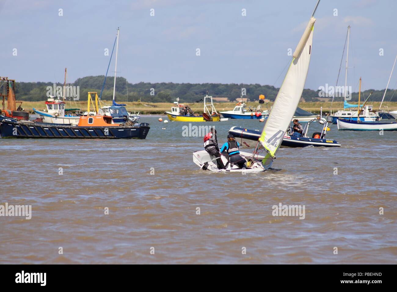 Suffolk, UK. 28th July 2018. UK Weather: Dinghy sailors contending with strong gusty winds this morning on the River Deben at Felixstowe Ferry, Suffolk. Credit: Angela Chalmers/Alamy Live News Stock Photo