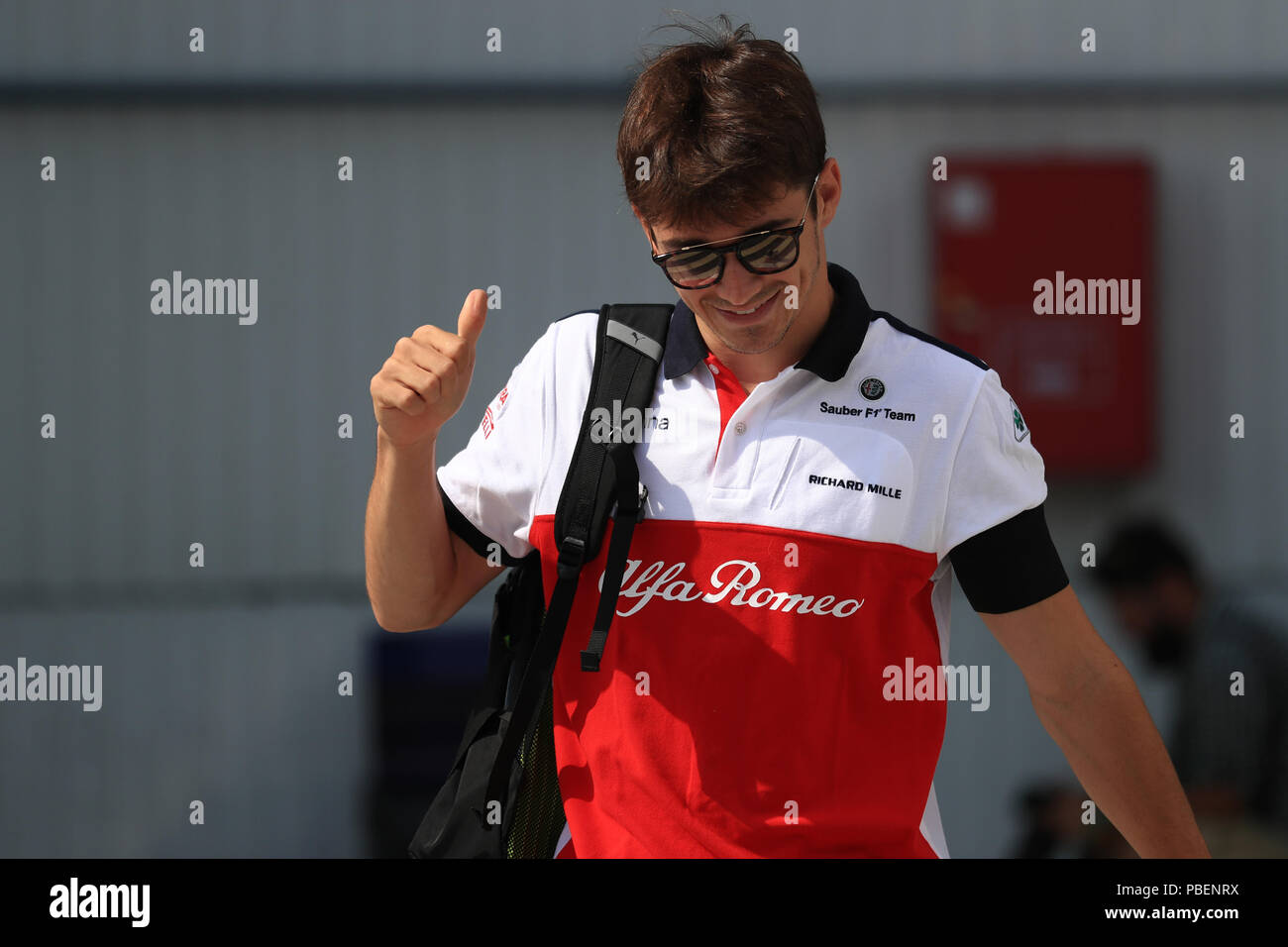 Hungaroring, Mogyorod, Hungary. 28th July, 2018. Hungarian Formula One  Grand Prix, qualification; Alfa Romeo Sauber F1 Team, Charles Leclerc gives  thumbs up coming into the paddock Credit: Action Plus Sports/Alamy Live News