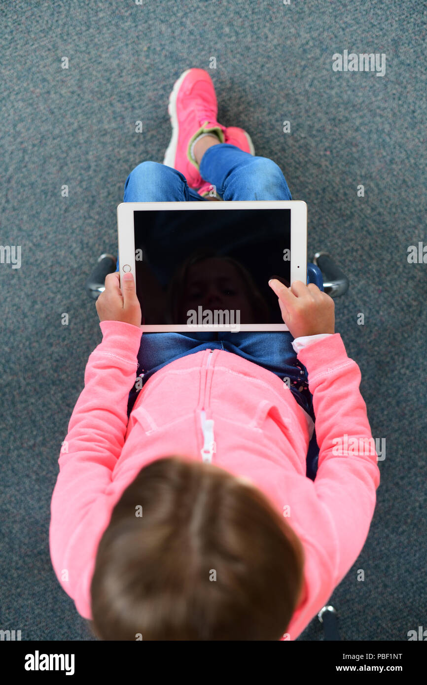 Girl 9 10 11 on an ipad with a blank screen copy space elementary school age Stock Photo