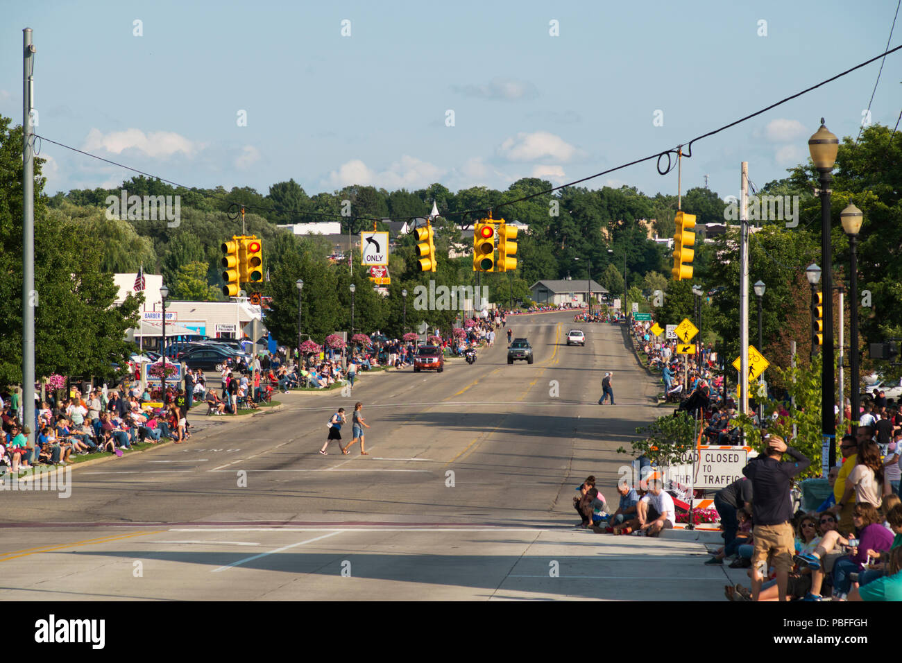 People waiting for the annual 2018 Cruz-In parade of antique and vintage vehicles through Montague, Michigan. Stock Photo