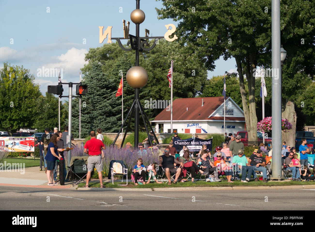 People waiting for the annual 2018 Cruz-In parade of antique and vintage vehicles through Montague, Michigan. Stock Photo