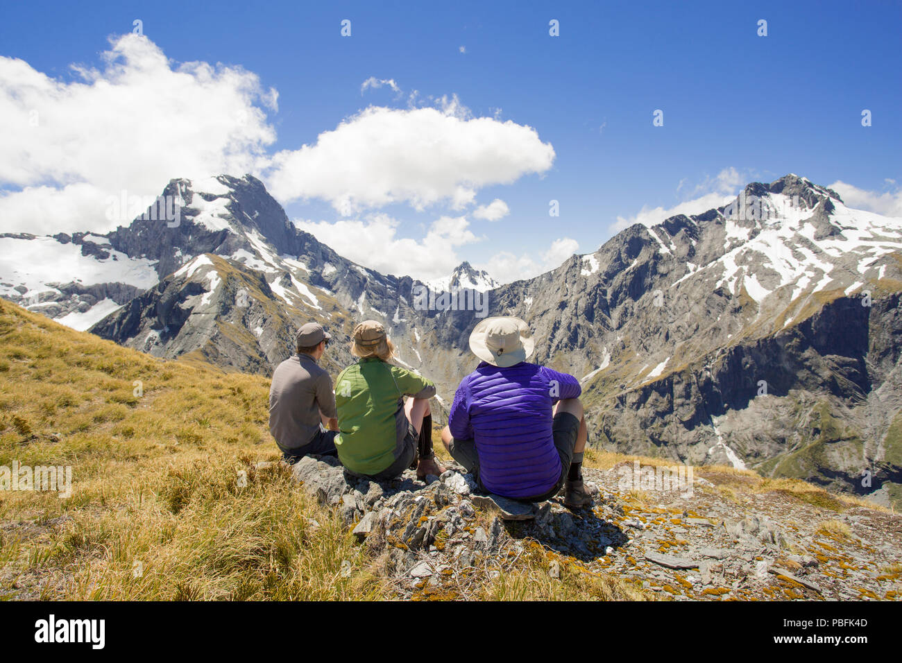 New Zealand aka Aotearoa, South Island, Mt Aspiring National Park, Gillespie Pass, trampers with scenic view of Mt Awful. Model released. Stock Photo