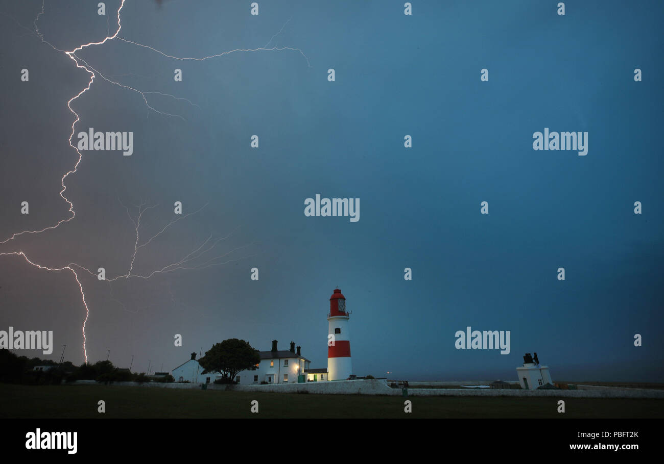 Lightning flashes over Souter lighthouse in South Shields as heavy thunderstorms marked the end of the UK heatwave on Friday. Stock Photo