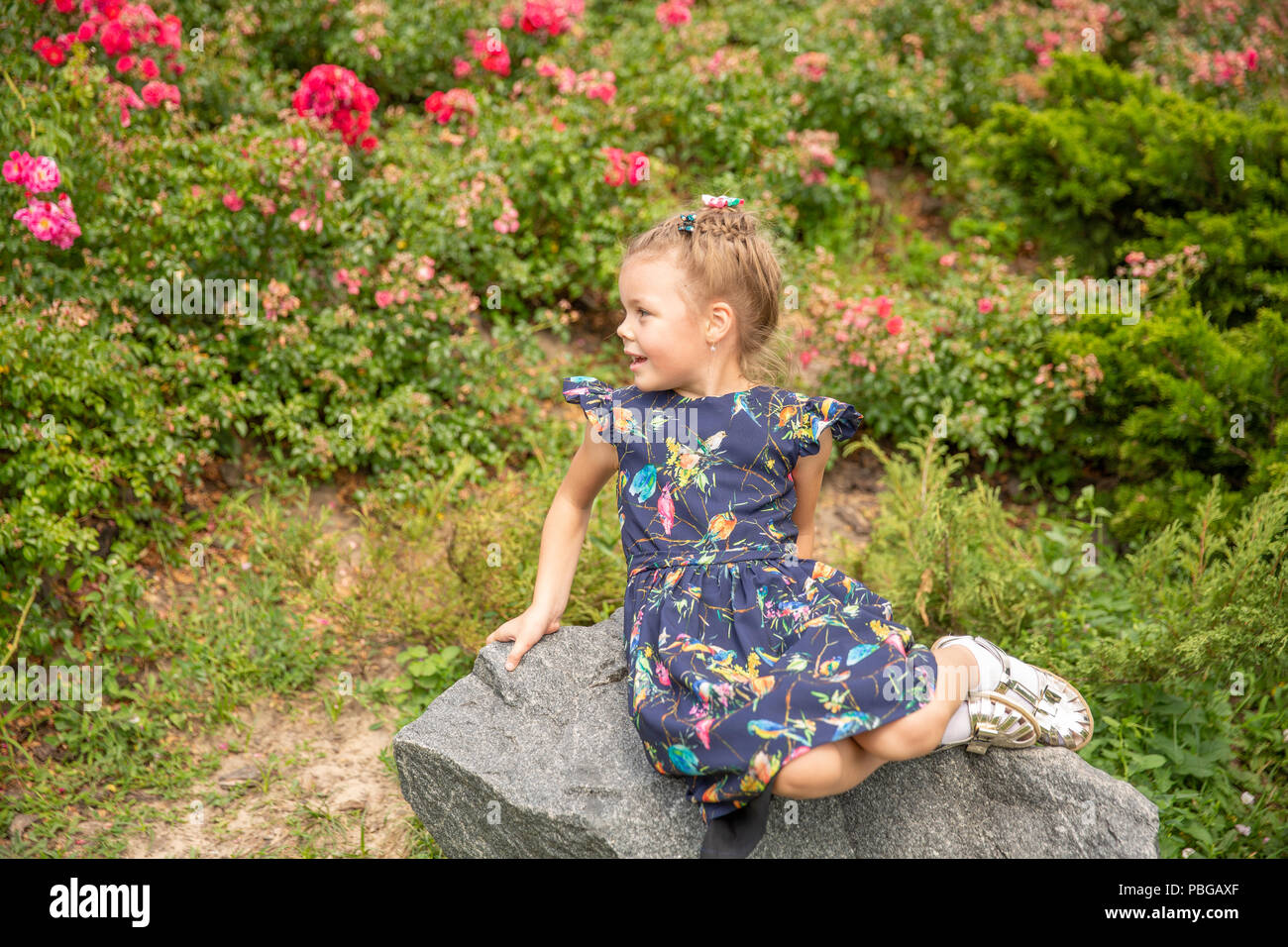 alone girl sitting on the stone in park Stock Photo - Alamy