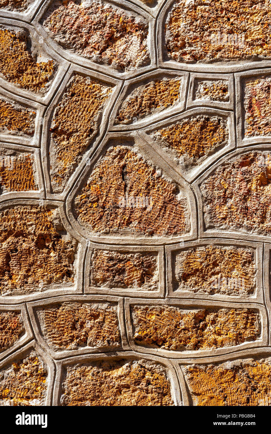 Cemented natural stone wall background Stock Photo