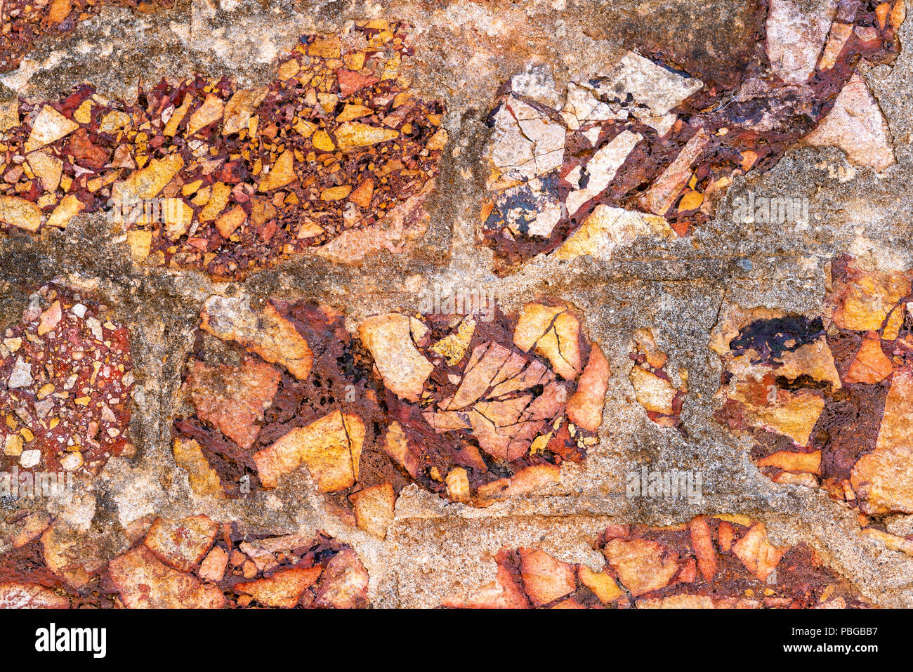 Cemented naural flint rough yellow stone wall background Stock Photo
