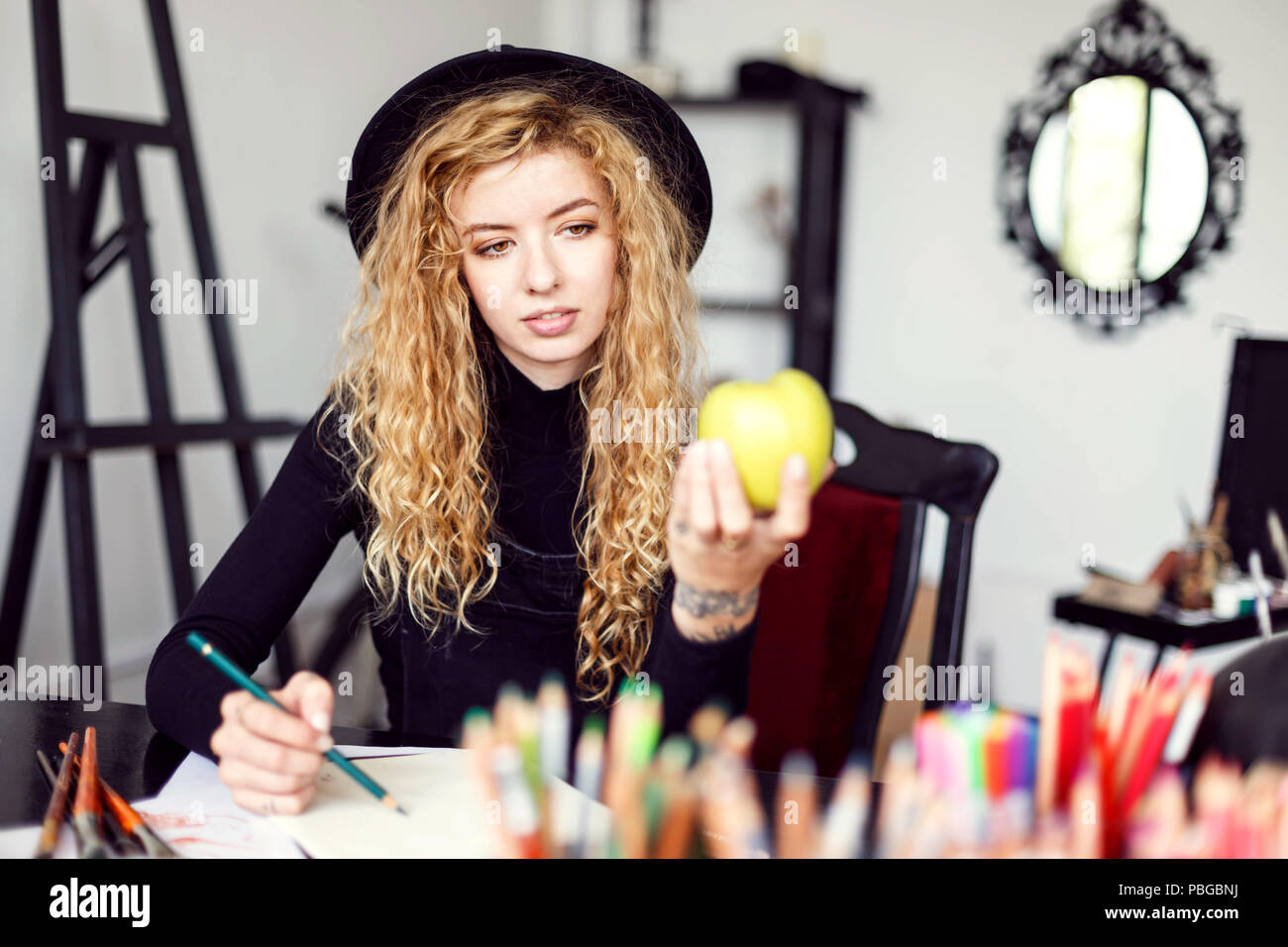 Romantic Blonde Long Hair Curly Feemale Artist In Black Hat