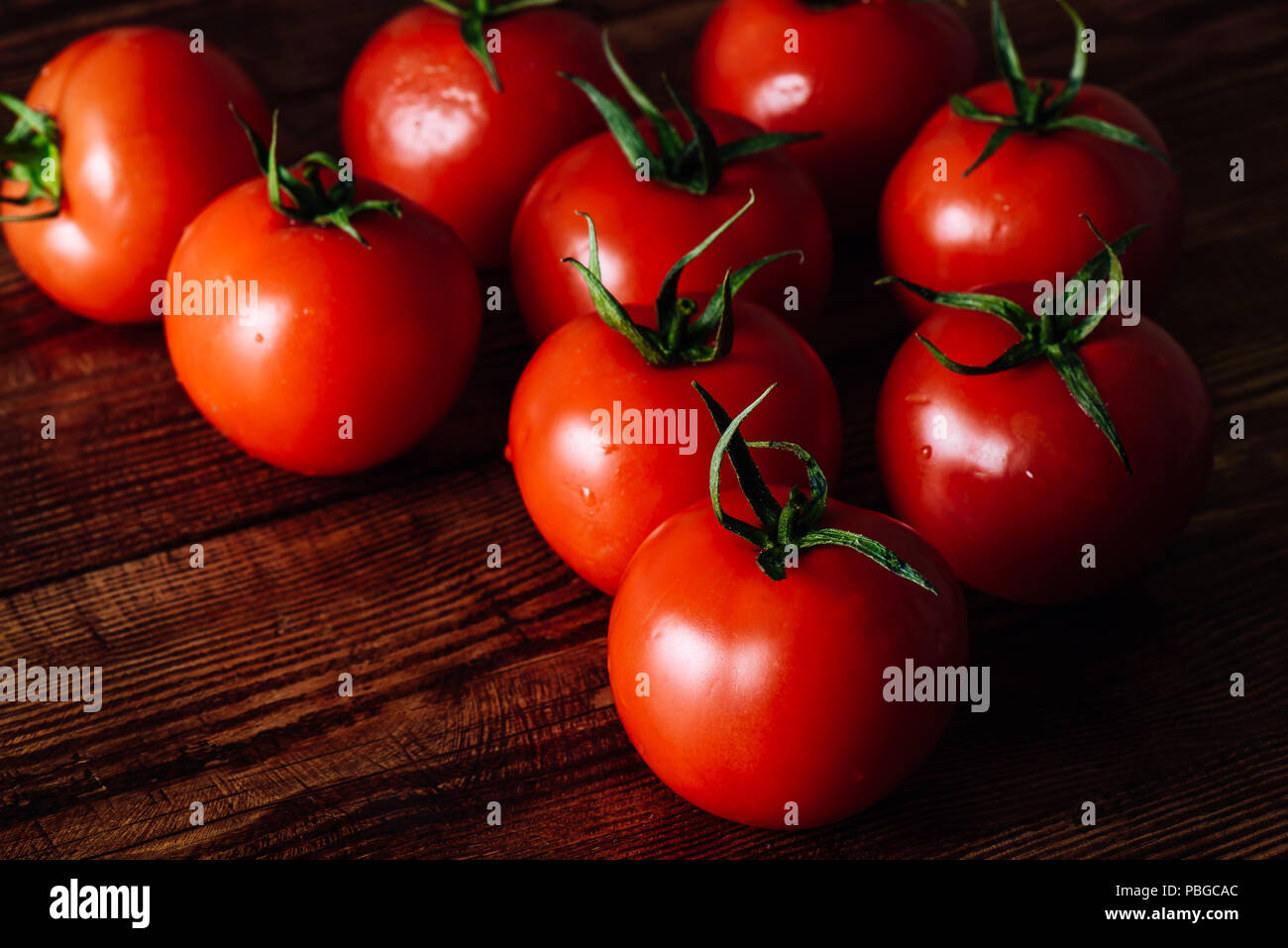 Red Ripe Tomatoes Scattered on Wooden Table Stock Photo - Alamy