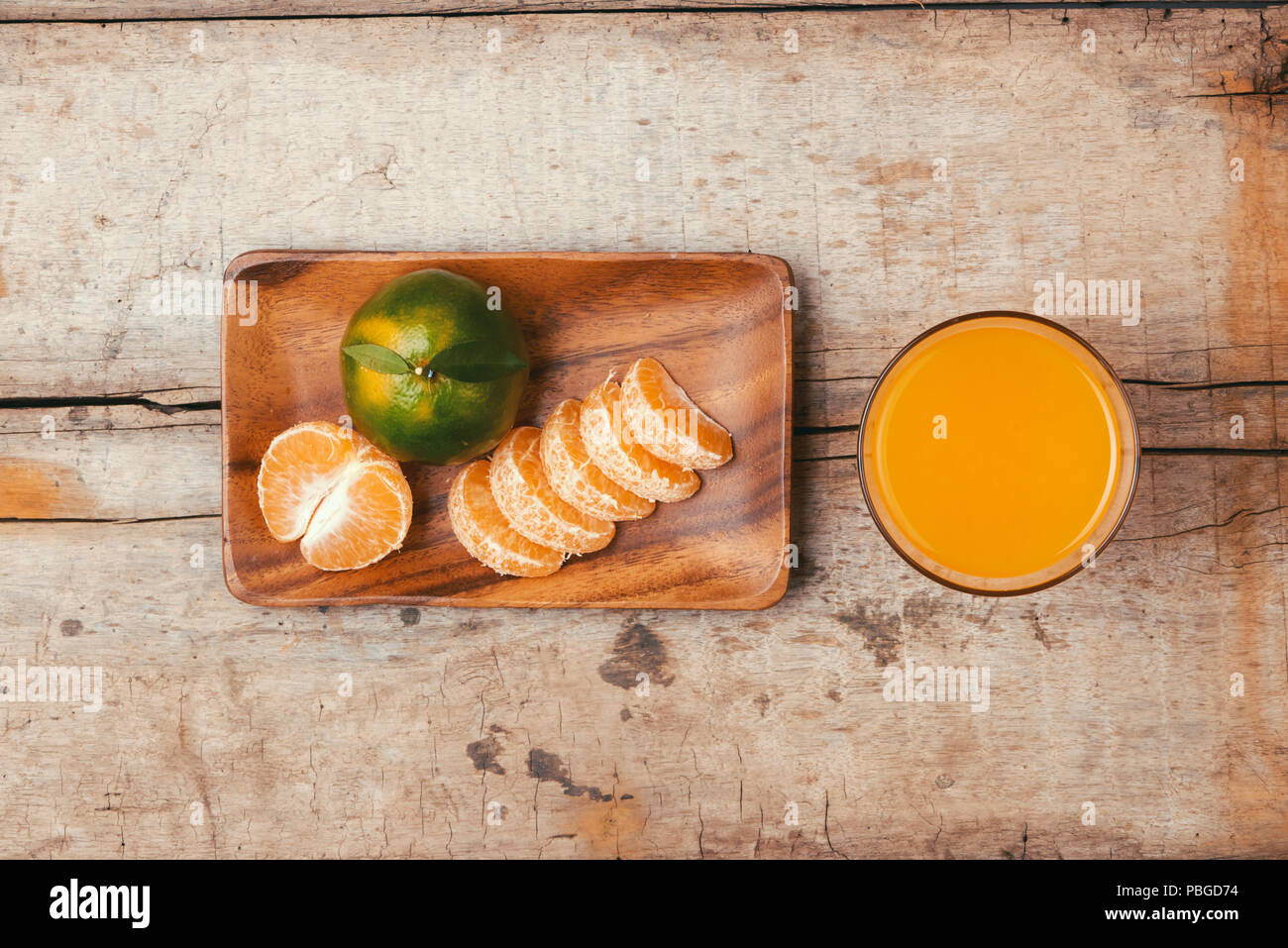 glasses of tangerines orange juice and fruits, high vitamin C Stock