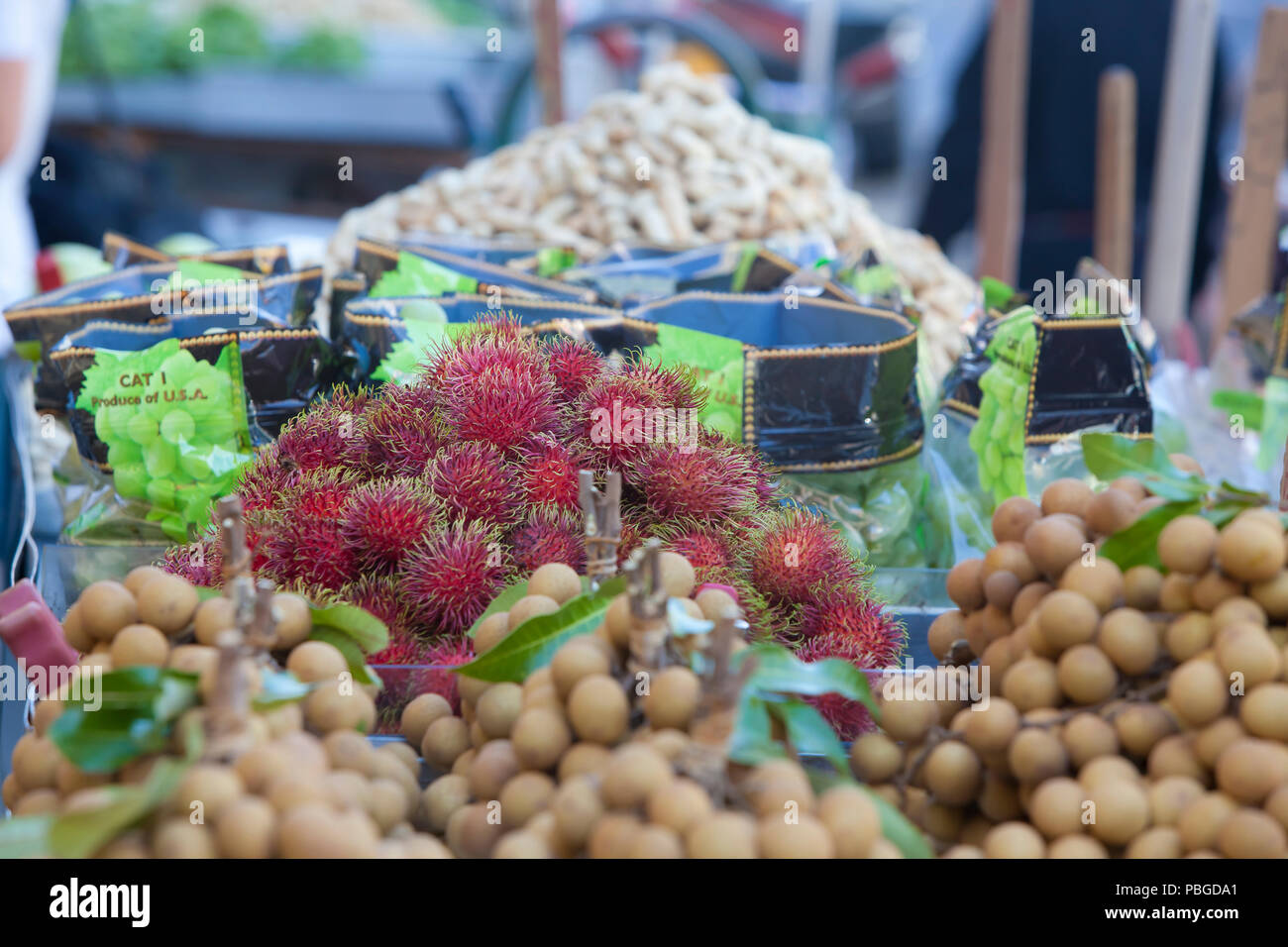 Rambutan and other fruit for sale at an outdoor stand in Chinatown, New York Stock Photo