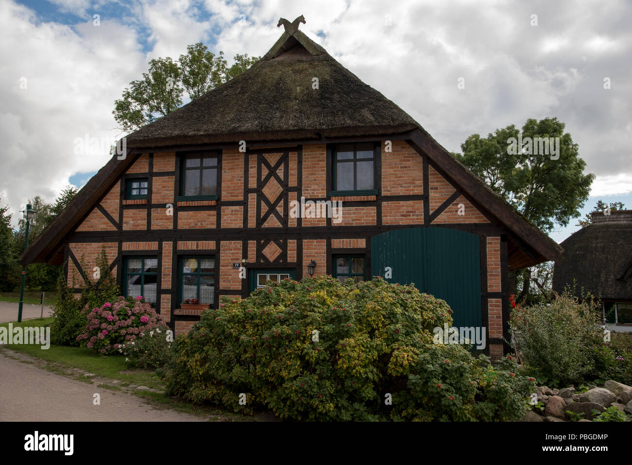 Thatch-roof house in Groß-Stresow in the southeast of Ruegen Island in the Baltic Sea in Northeastern Germany. Stock Photo